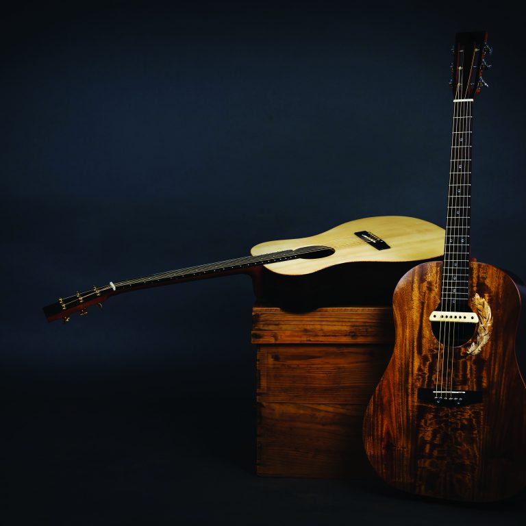 Acoustic guitar on a chair and close-up brown guitar in black background.