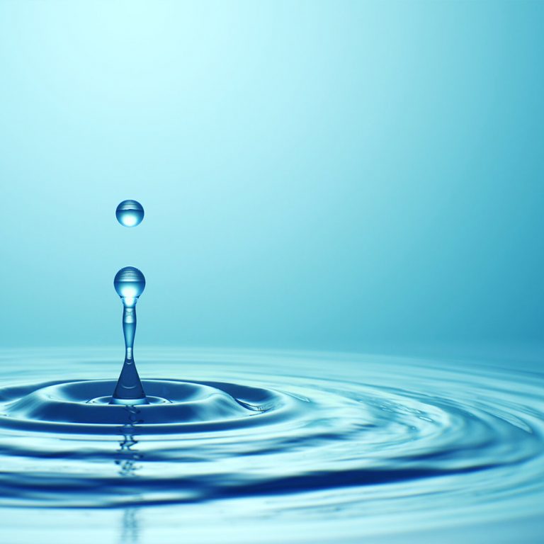 Water,Drop,With,Droplet,And,Rings,On,Surface,Bluish,Background