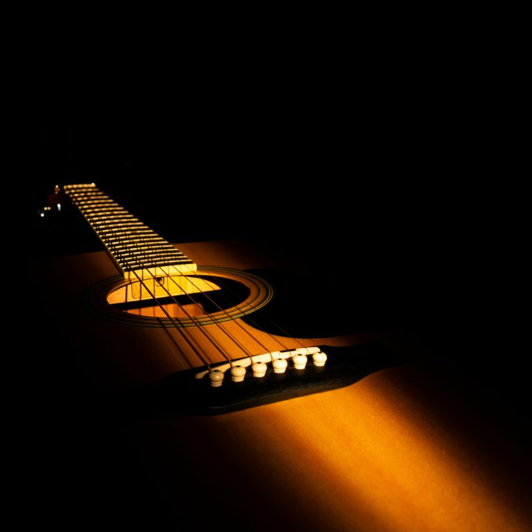 Beam,Of,Light,Illuminates,Yellow,Wooden,Acoustic,Guitar.,Stringed,Musical