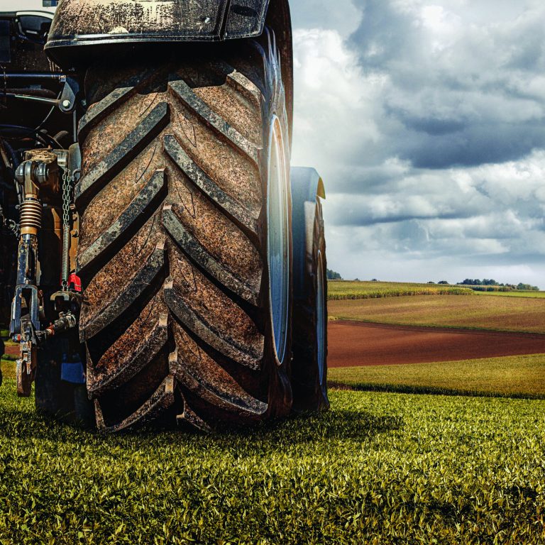 Tractor from behind in a field during harvest