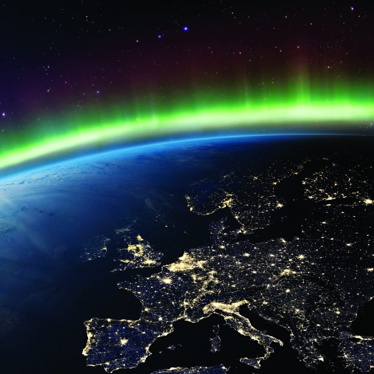Planet Earth from the space at night and Northern Lights or Aurora Borealis related to the Earth's magnetic field. Europe at night viewed from space. Elements of this image furnished by NASA.