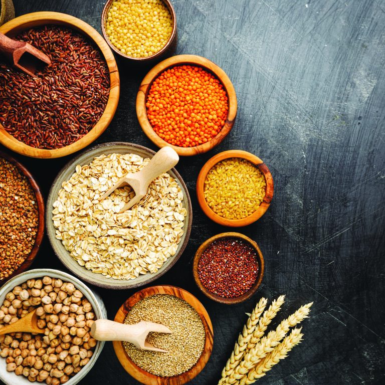 Organic products. Bowls with different gluten free grains on black background, top view